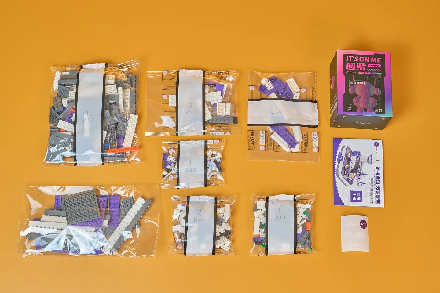YTO gift set contents with numbered brick bags, instructions and character packaging