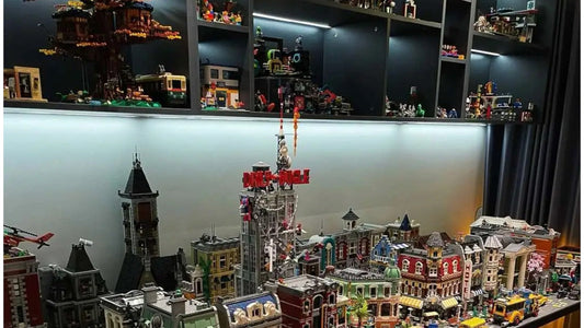 LEGO display room with lit shelves and a large brick city setup