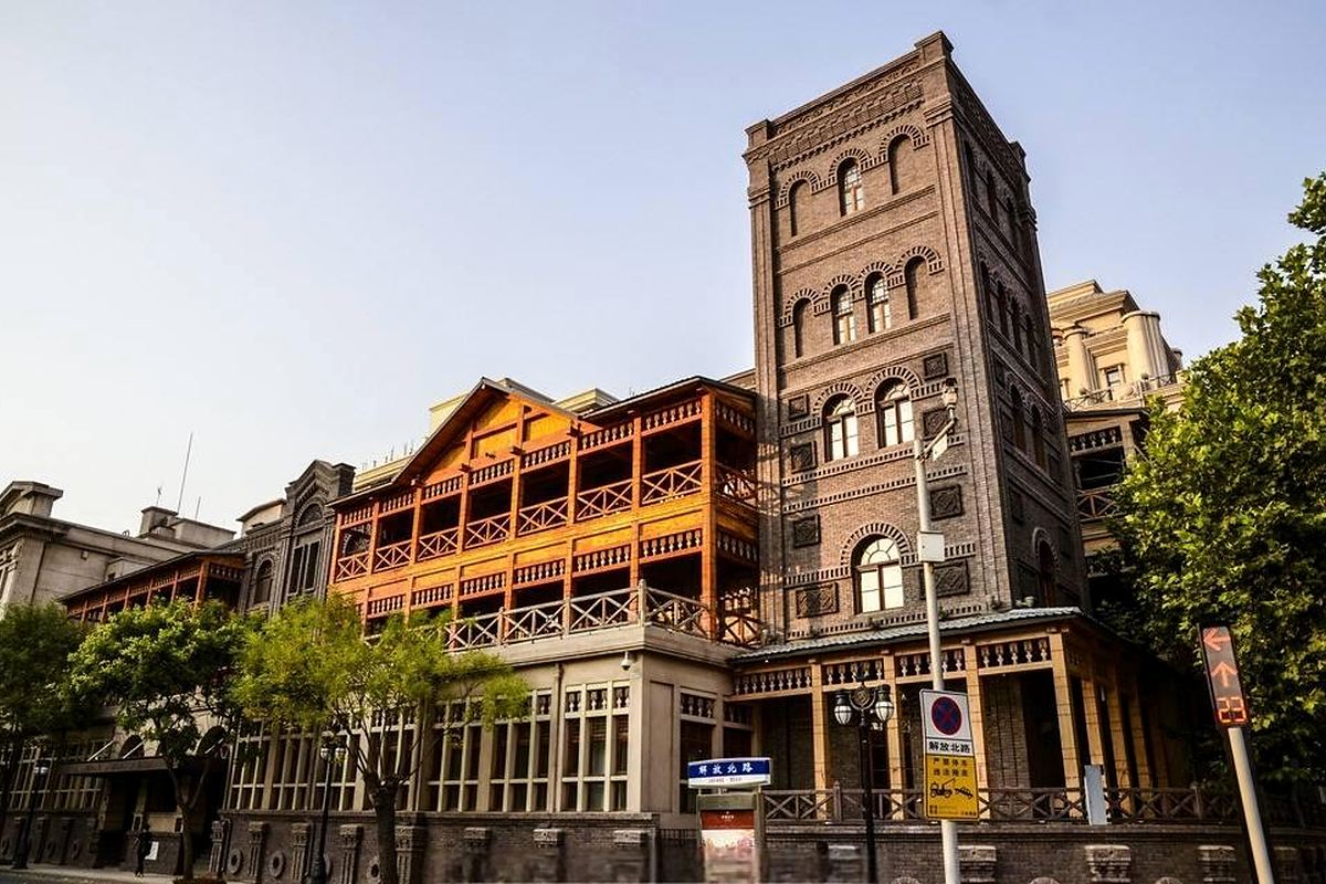 Present-day red-brick facade, timber verandas and tower of The Astor Hotel Tianjin