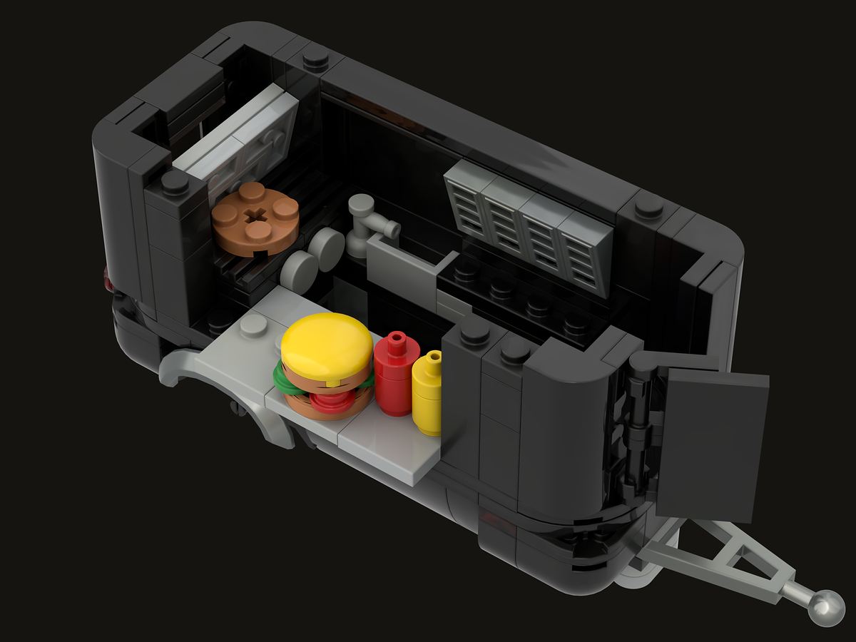 Open interior view of the ZEST EXPRESS brick food trailer with kitchen equipment and serving counter
