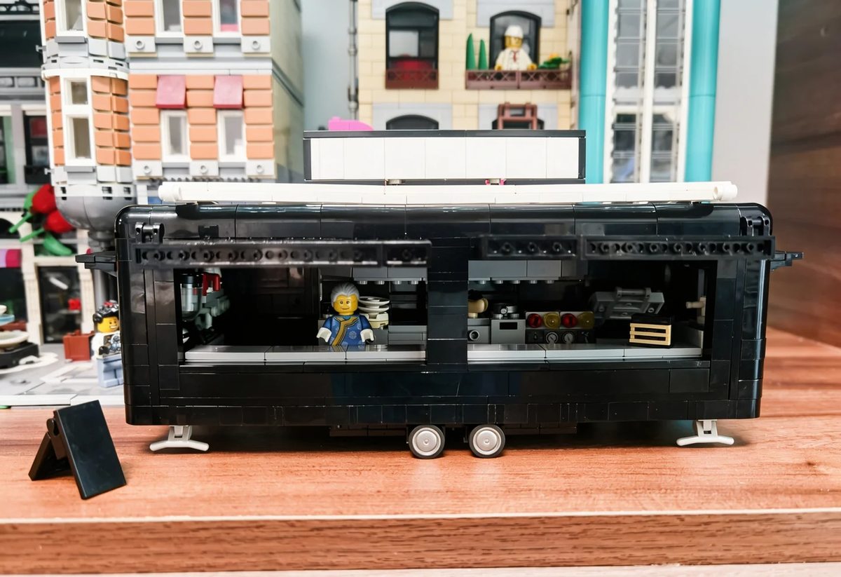 Completed large black food-trailer MOC by Banbei Ningmeng, with serving windows, wheels and support legs