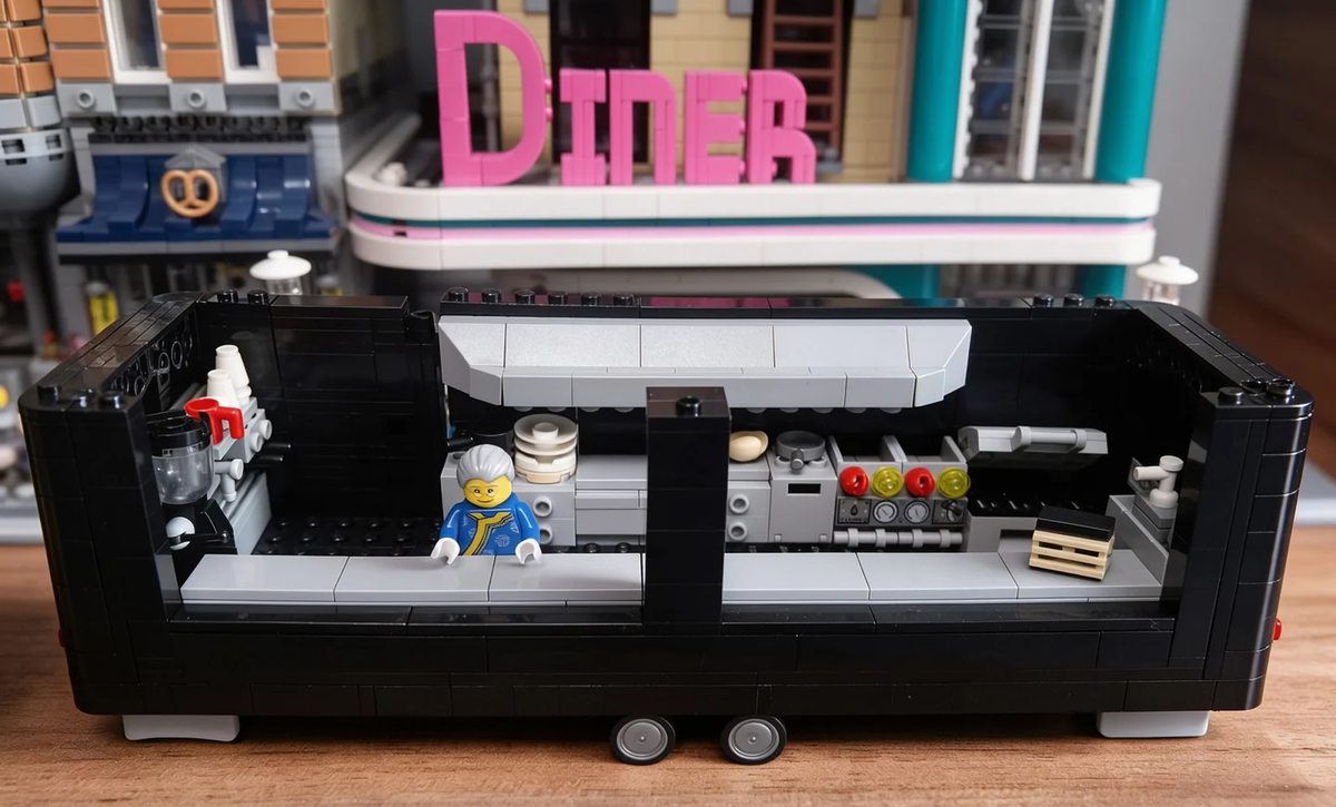 Open-roof interior of Banbei Ningmeng’s large food-trailer MOC showing counters, cups, plates and kitchen equipment