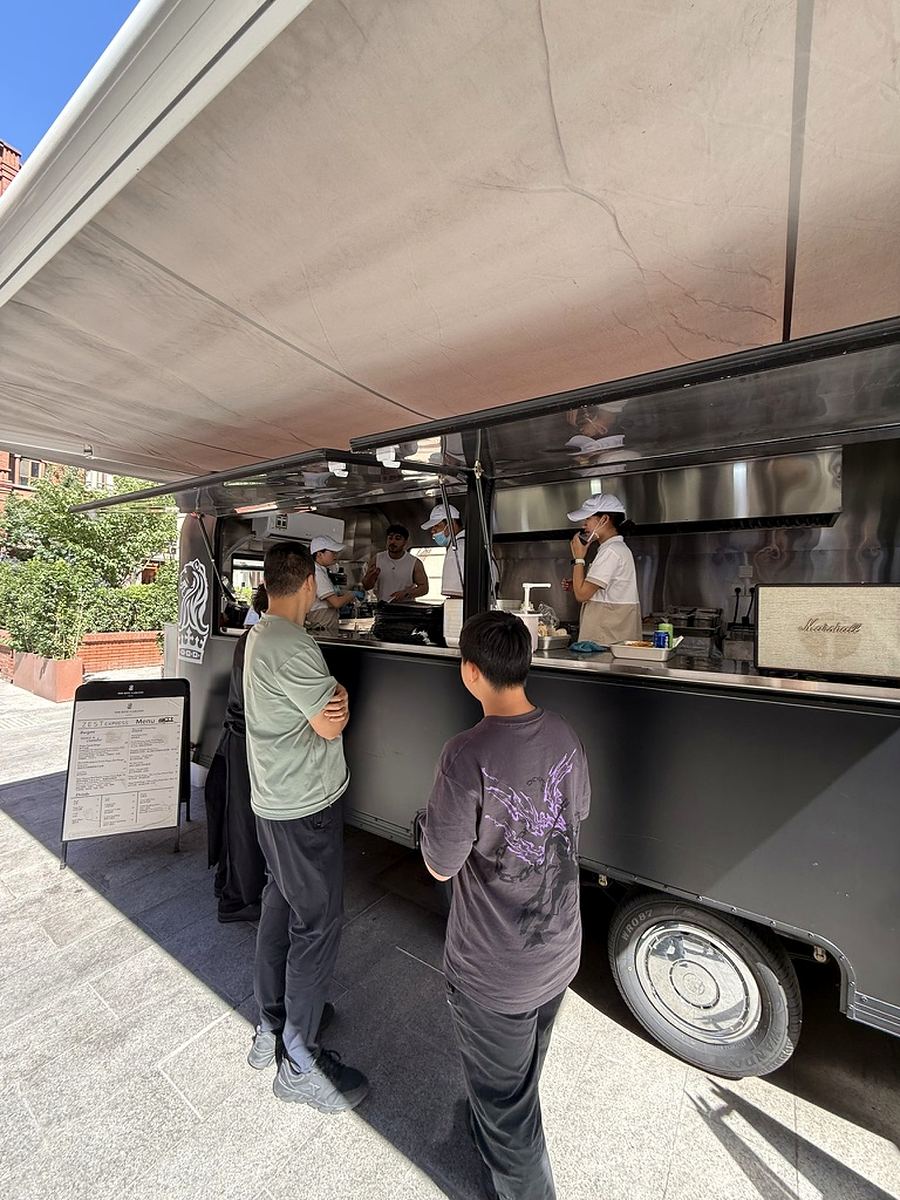 Hotel team serving guests from the ZEST EXPRESS mobile food trailer