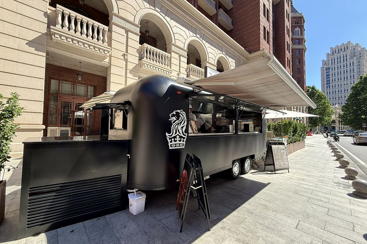 Full-size black ZEST EXPRESS food trailer outside The Ritz-Carlton, Tianjin