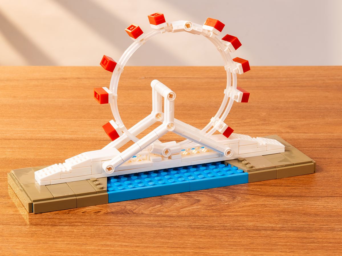 197-piece Tianjin Eye building-block model with Ferris wheel mounted above a bridge and blue water