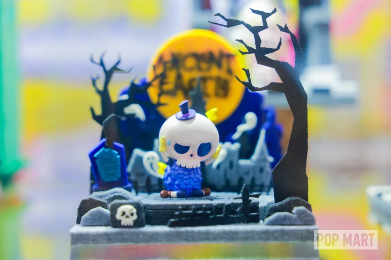 Blue collectible figure in a moonlit miniature setting