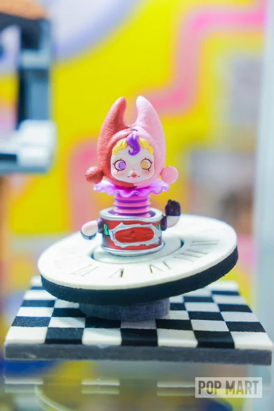 Pink collectible figure displayed on a circular stage
