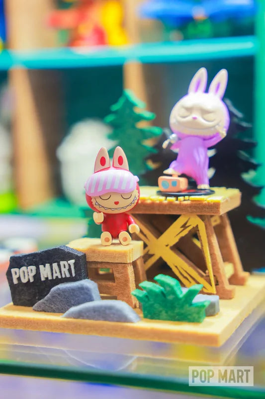 Two collectible figures arranged on woodland platforms