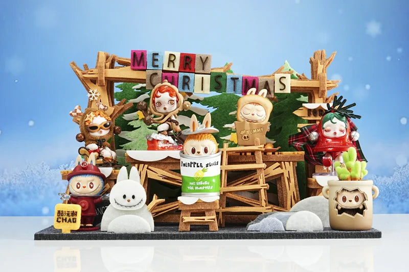 Collectible figures on a layered woodland display with festive lettering